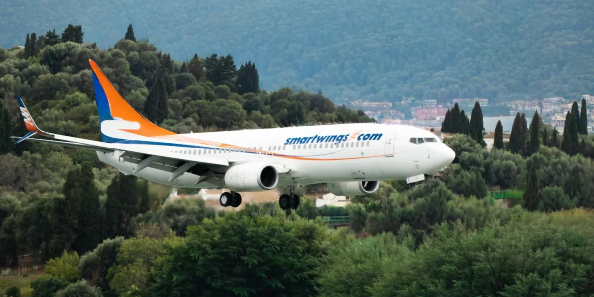 Airplane from Smartwings landing over the green landscapes of Corfu, Greece.