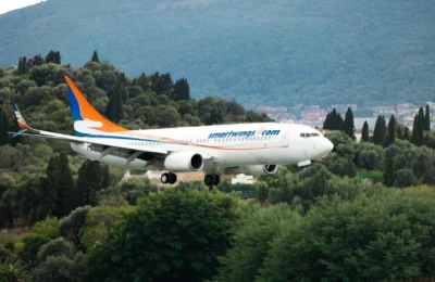 Airplane from Smartwings landing over the green landscapes of Corfu, Greece.