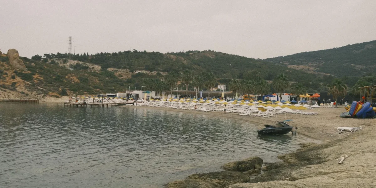 A serene beach with chairs and rocky coastline in Izmir, Turkey.