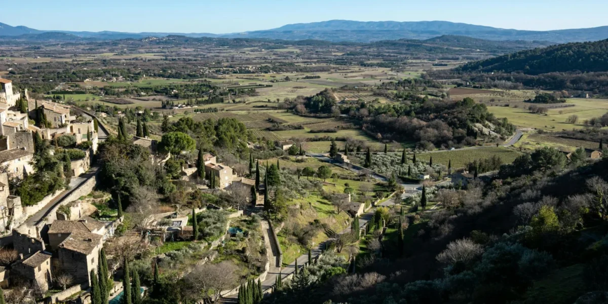 Aerial view of Gordes, a beautiful village in Provence, France with lush landscapes and historic architecture.