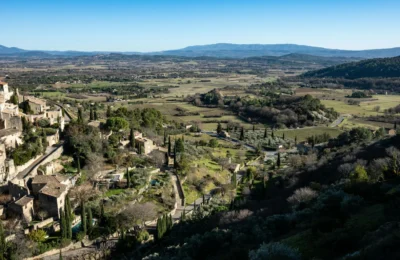 Aerial view of Gordes, a beautiful village in Provence, France with lush landscapes and historic architecture.