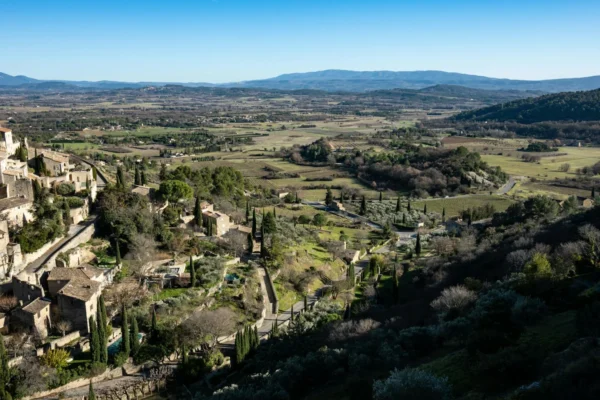 Aerial view of Gordes, a beautiful village in Provence, France with lush landscapes and historic architecture.