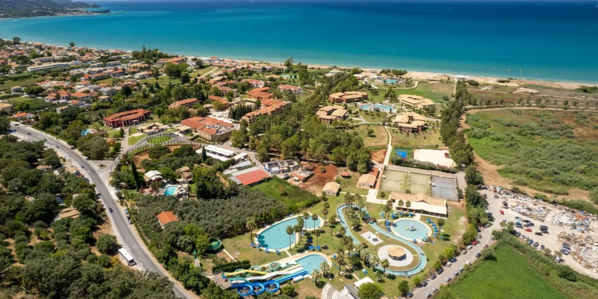 Stunning aerial view of a resort and water park in Corfu, Greece by the sea.