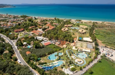 Stunning aerial view of a resort and water park in Corfu, Greece by the sea.