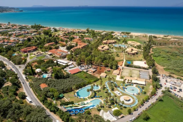 Stunning aerial view of a resort and water park in Corfu, Greece by the sea.