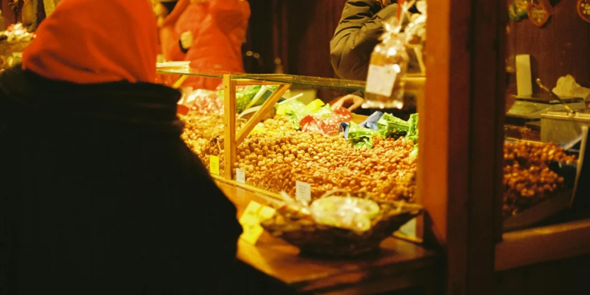 Cozy winter scene of a traditional Christmas market in Berlin, showcasing festive treats.
