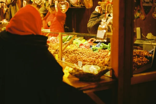 Cozy winter scene of a traditional Christmas market in Berlin, showcasing festive treats.