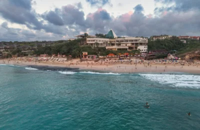 Scenic aerial view of a beachfront resort in Bali, Indonesia at sunset.