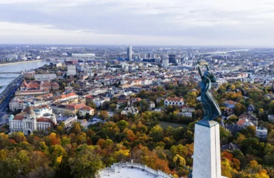 Stunning aerial view of Budapest with the iconic Liberty Statue overlooking the city and Danube River.