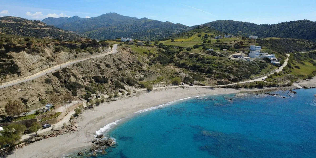 Stunning aerial view of Triopetra Beach showcasing the vibrant blue sea and surrounding hills in Crete, Greece.