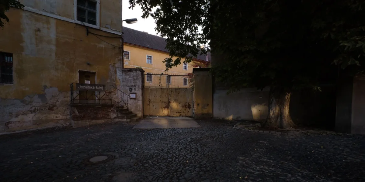 A quiet, historic courtyard surrounded by old buildings in Jičín, Czech Republic.