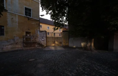 A quiet, historic courtyard surrounded by old buildings in Jičín, Czech Republic.