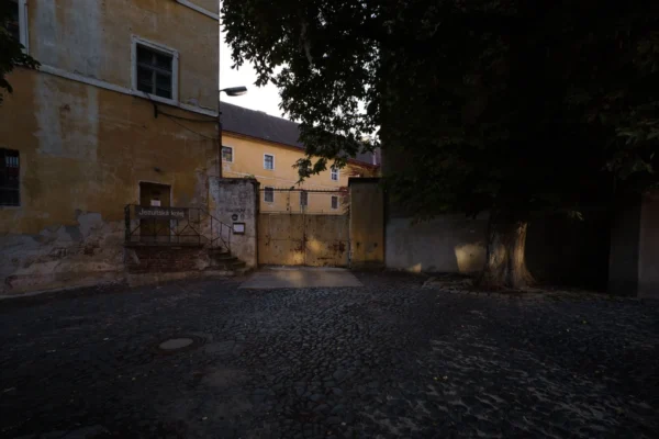 A quiet, historic courtyard surrounded by old buildings in Jičín, Czech Republic.