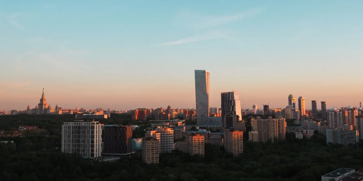 Cityscape of Moscow featuring skyscrapers and iconic architecture during sunset.