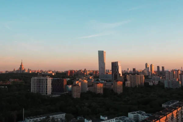 Cityscape of Moscow featuring skyscrapers and iconic architecture during sunset.