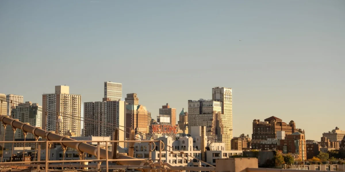 Explore the iconic skyline of New York City captured from Brooklyn Bridge, showcasing urban architecture and vibrant city life.
