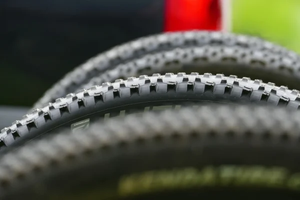 Detailed close-up of mountain bike tires showcasing tread design for off-road cycling.