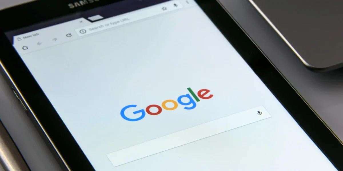 Close-up of a tablet displaying Google's search screen, emphasizing technology and internet browsing.