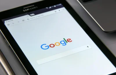 Close-up of a tablet displaying Google's search screen, emphasizing technology and internet browsing.