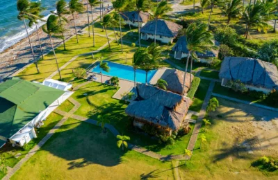 Stunning aerial view of a tropical resort in Bacong, Philippines, showcasing palm trees, beach, and swimming pool.