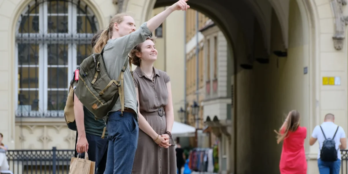 Group of travelers exploring a historic city landmark with enthusiasm and curiosity.
