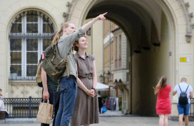 Group of travelers exploring a historic city landmark with enthusiasm and curiosity.