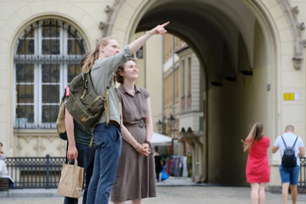 Group of travelers exploring a historic city landmark with enthusiasm and curiosity.