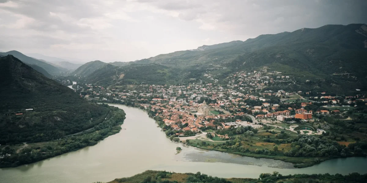 Explore a stunning aerial view of Mtskheta, where the Mtkvari and Aragvi rivers converge in Georgia's scenic landscape.