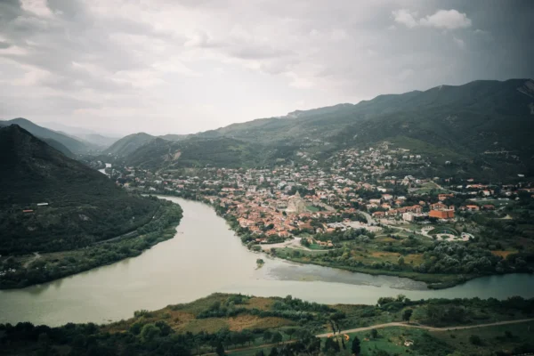 Explore a stunning aerial view of Mtskheta, where the Mtkvari and Aragvi rivers converge in Georgia's scenic landscape.