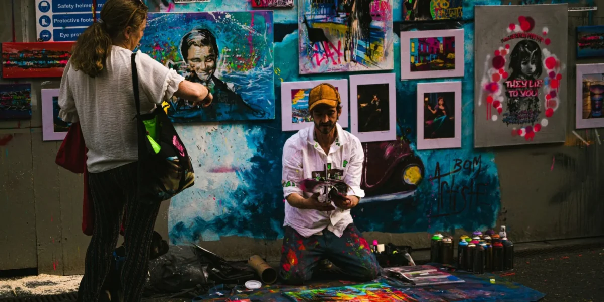Colorful street art scene with artist and viewer in Galway, Ireland.