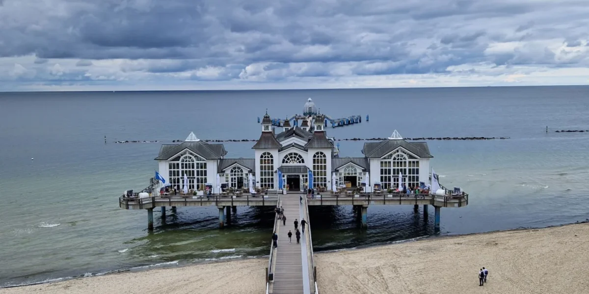 A breathtaking view of Sellin Pier extending over the calm Baltic Sea under a cloudy sky.