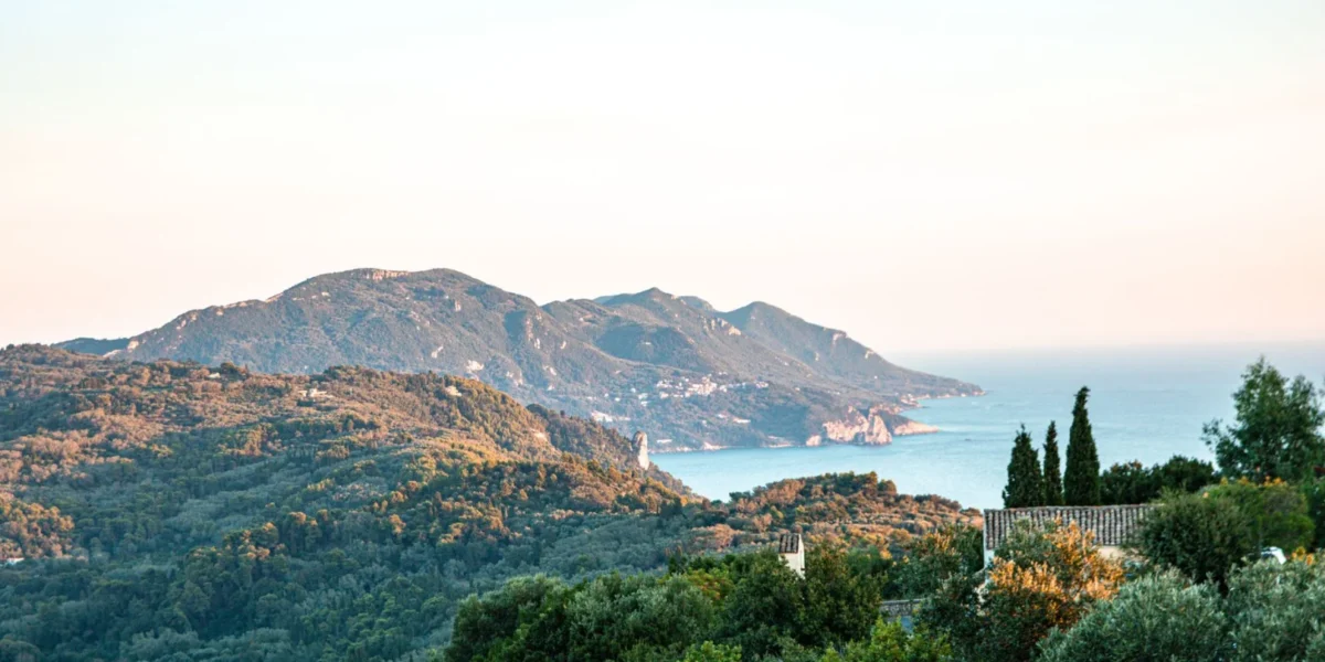 Breathtaking landscape view of Korfu, Greece, showcasing lush greenery and the Mediterranean Sea.