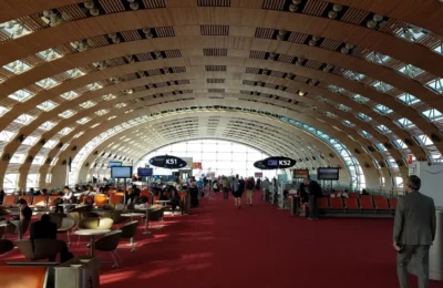 Travelers in the modern, spacious terminal of Charles de Gaulle Airport, Paris.