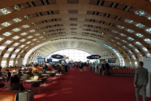 Travelers in the modern, spacious terminal of Charles de Gaulle Airport, Paris.