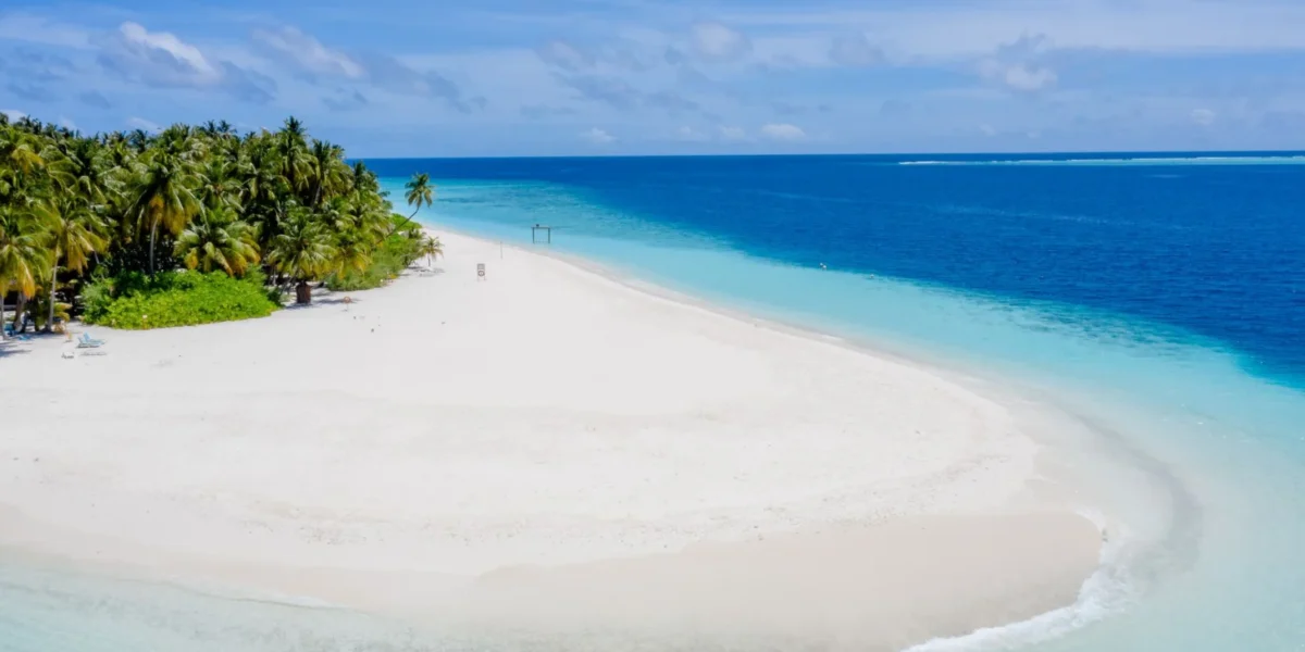 Beautiful white sandy beach with turquoise waters in Guraidhoo, Maldives, showcasing serene tropical paradise.
