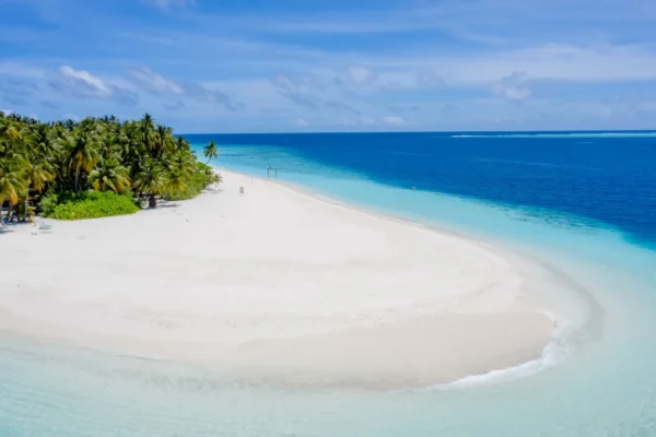 Beautiful white sandy beach with turquoise waters in Guraidhoo, Maldives, showcasing serene tropical paradise.