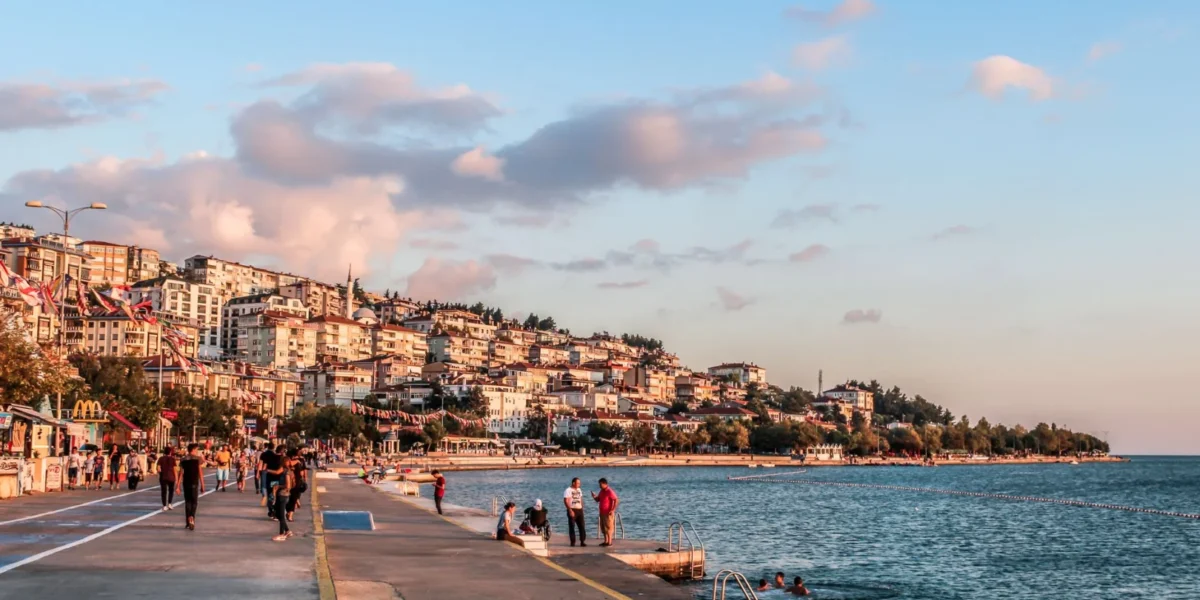 Enjoy a scenic walk along Istanbul's vibrant seaside promenade at sunset, capturing city life by the waterfront.