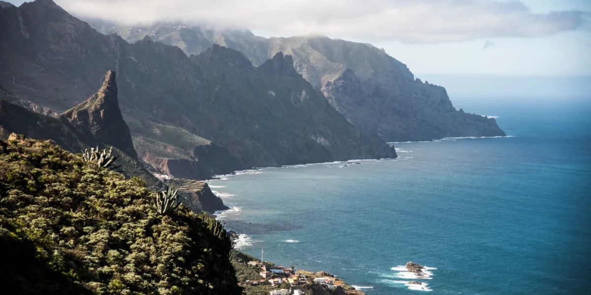 Breathtaking view of the rugged coastline and cliffs of Tenerife, Canary Islands, with ocean and mountains.