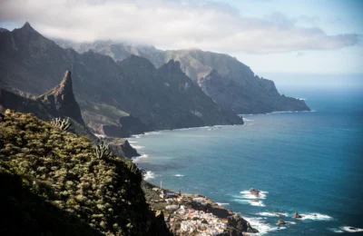Breathtaking view of the rugged coastline and cliffs of Tenerife, Canary Islands, with ocean and mountains.