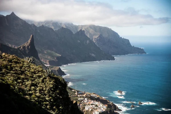Breathtaking view of the rugged coastline and cliffs of Tenerife, Canary Islands, with ocean and mountains.
