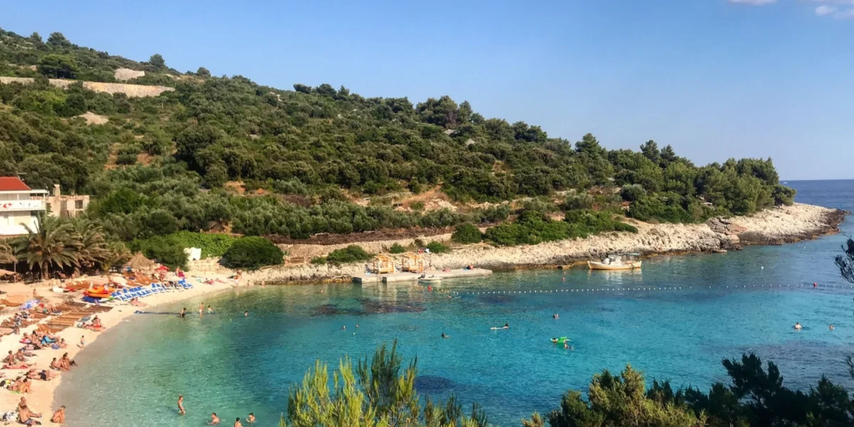 Scenic beach cove with clear turquoise waters at Vis Island, Croatia, perfect for a summer getaway.