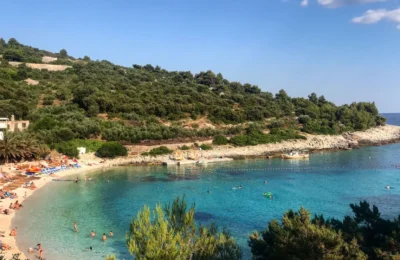 Scenic beach cove with clear turquoise waters at Vis Island, Croatia, perfect for a summer getaway.