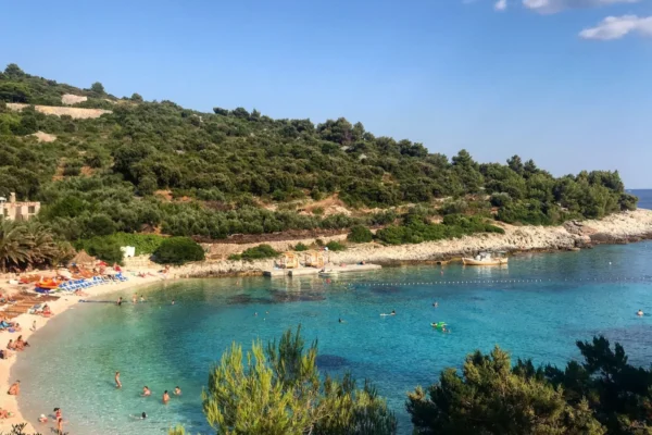 Scenic beach cove with clear turquoise waters at Vis Island, Croatia, perfect for a summer getaway.